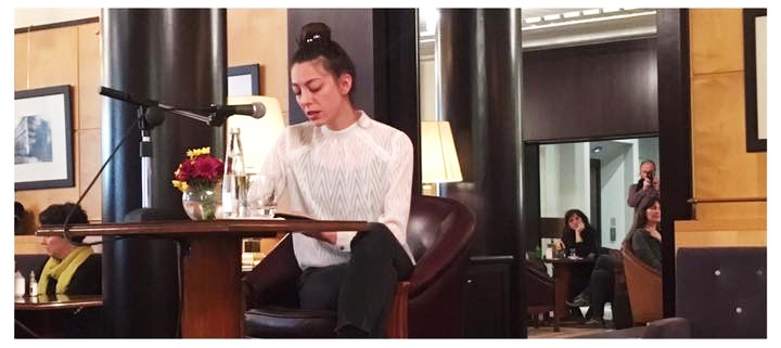 Ece Eldek reading poetry at a lectern during 5 O'clock Tea at Pera Museum