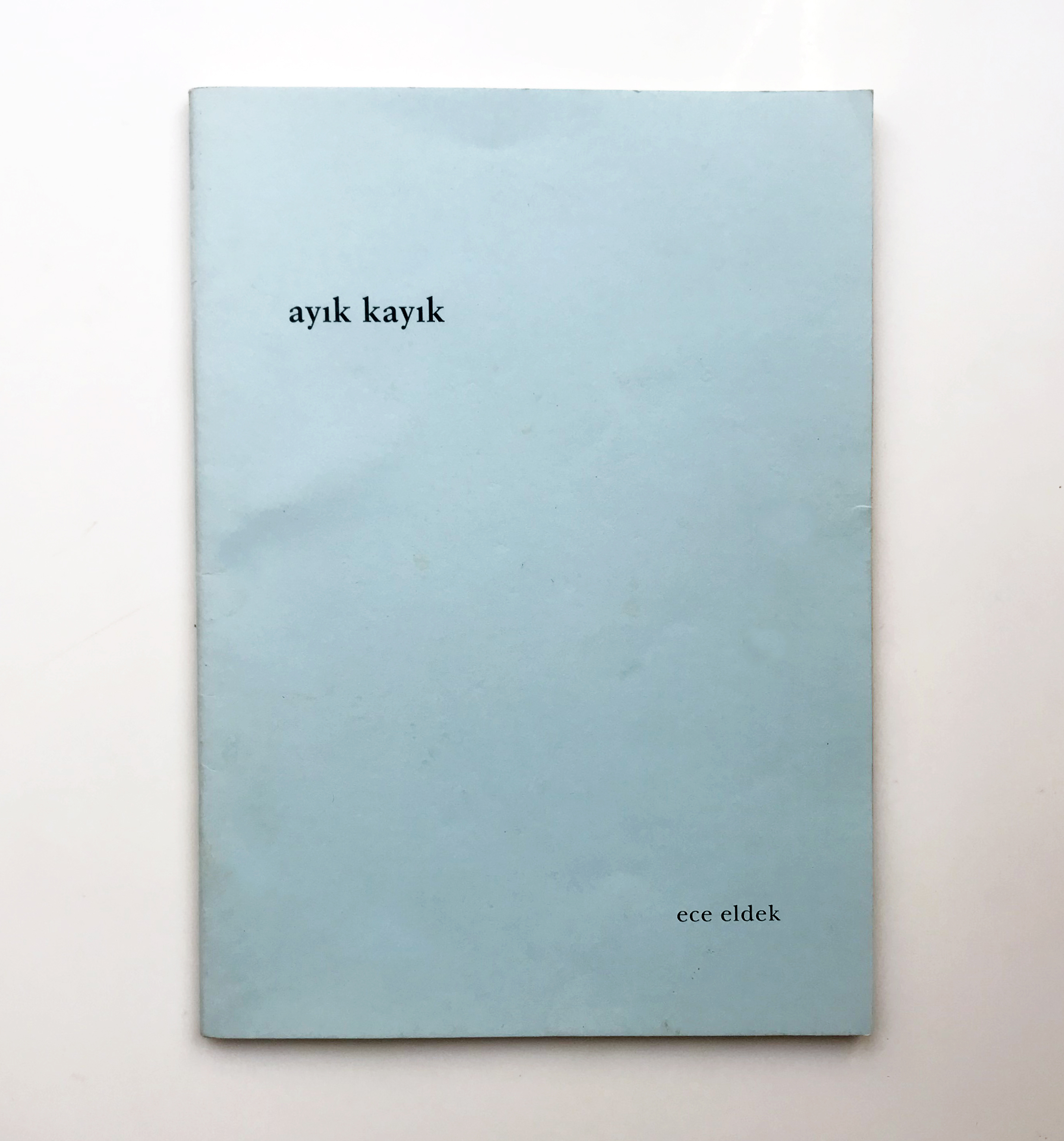 Light blue cover of the poetry book ayık kayık (sober boat) by Ece Eldek