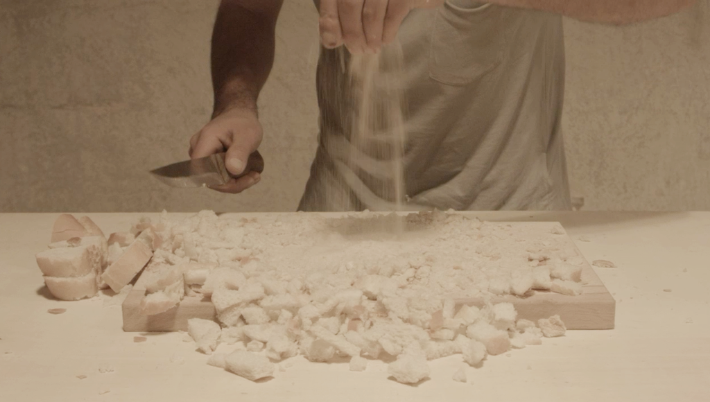 Bread reduced to crumbs and flour on a wooden board, still from ben bir yoksun un um