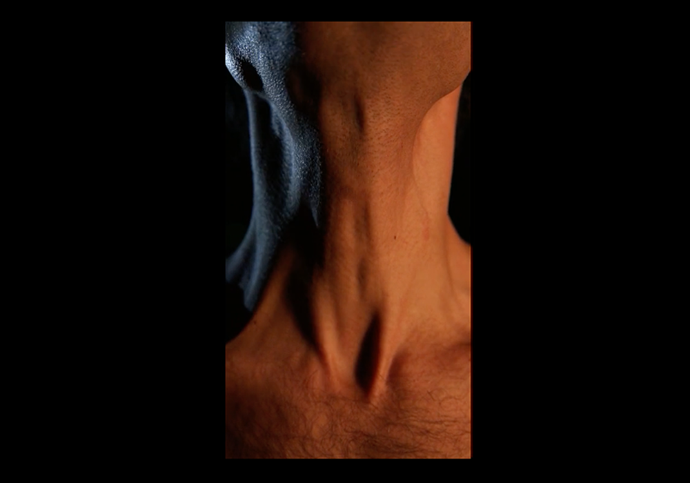 Close-up of a throat with a wisp of smoke, still from the video pathos