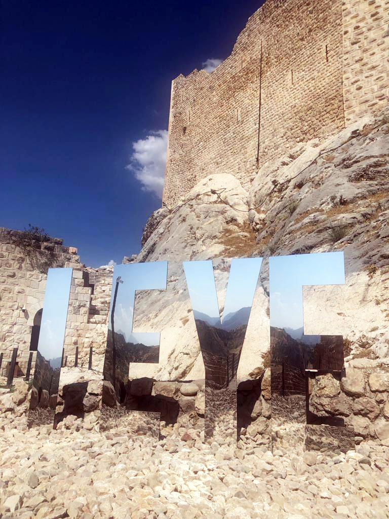 Sculpture I EYE below the fortress under a deep blue sky