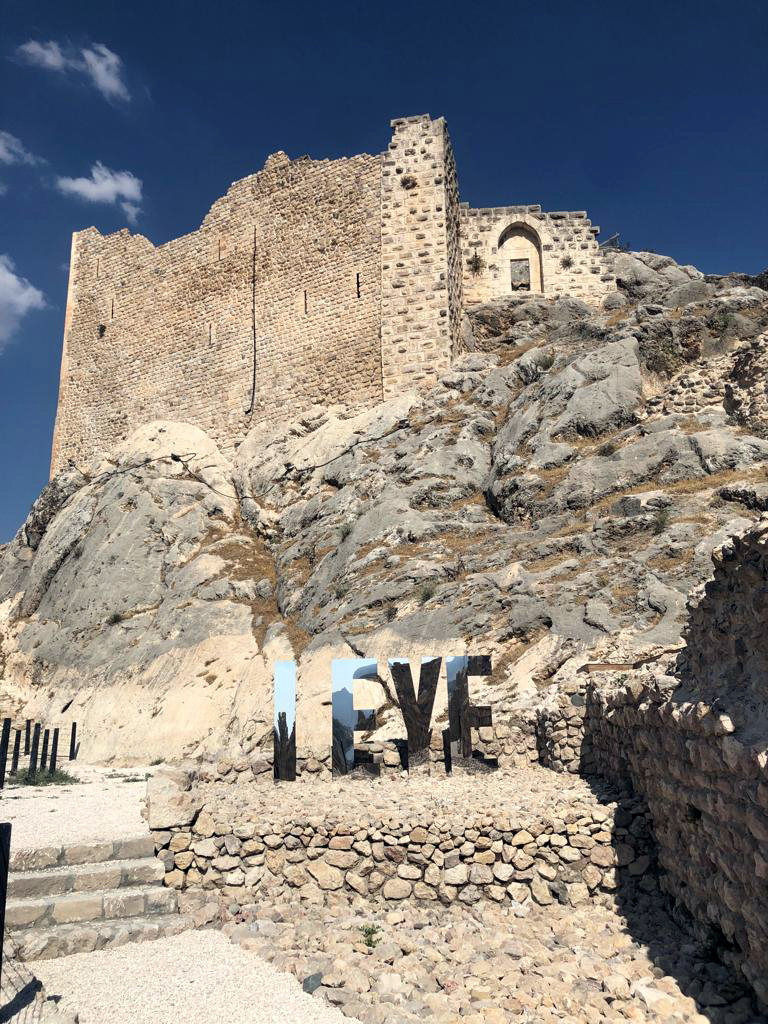 Distant view of I EYE at the foot of the fortress on the rocky hill