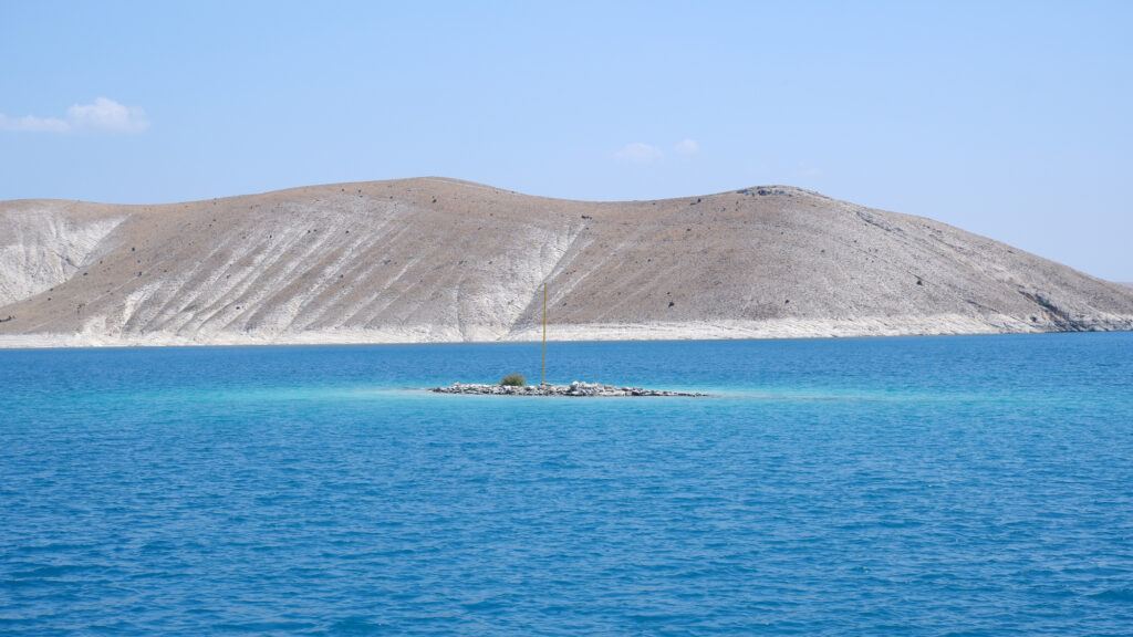 Wide view of the dam lake and hills around the installation Rising