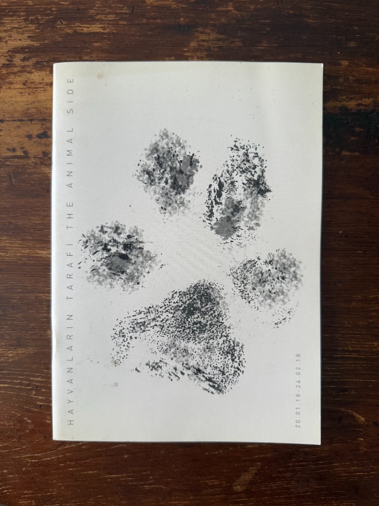 Cover of the exhibition publication Hayvanların Tarafı / The Animal Side, Mixer Gallery, with a paw print